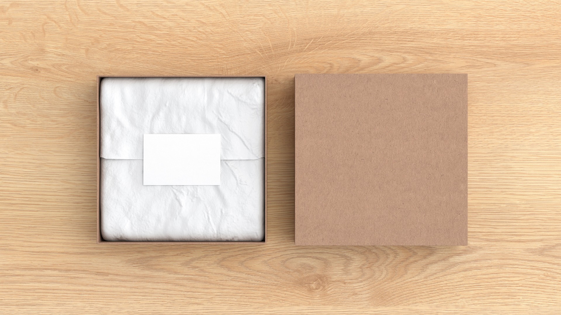 Square gift box mock up. Cardboard gift box with blank label or business card on wrapping paper. Wooden background. View directly above.