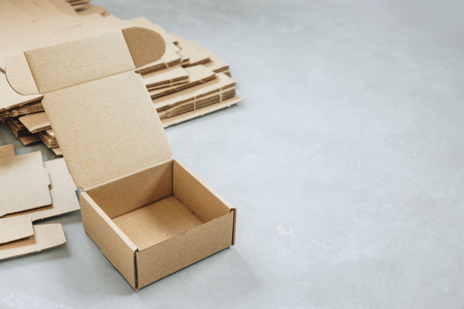 Paper Box. Brown paper Box. Brown cardboard box on gray background, opened empty inside. Square carton box for gift and delivery