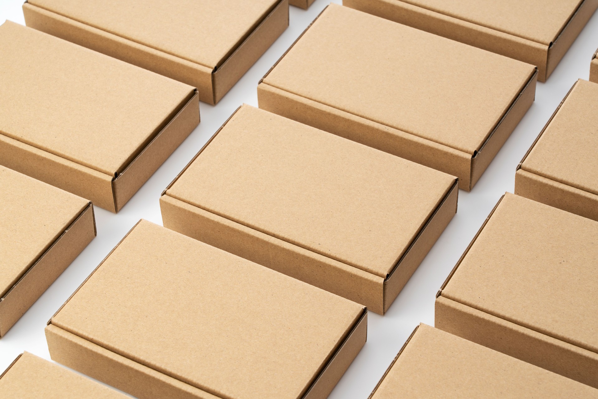 Neatly arranged cardboard boxes on a white background. Shipping Concept